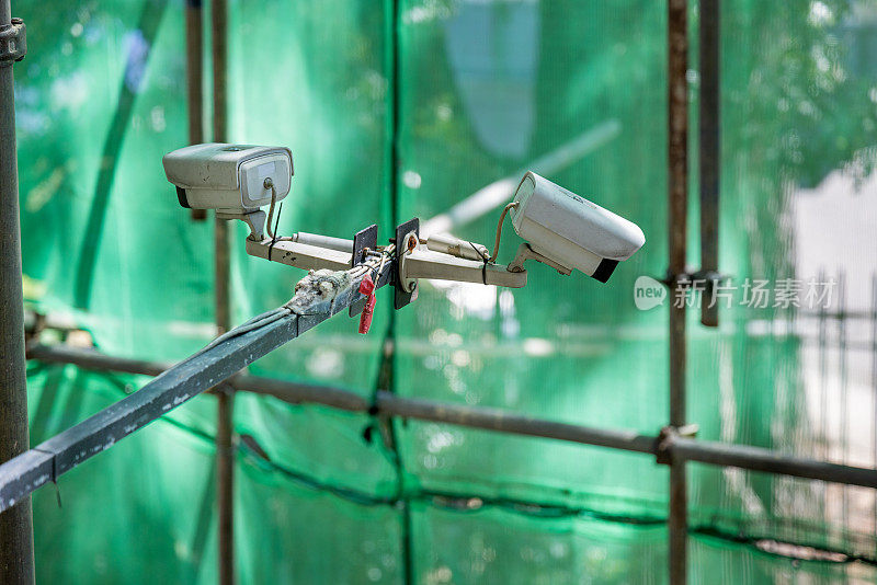 Two surveillance cameras at a construction site